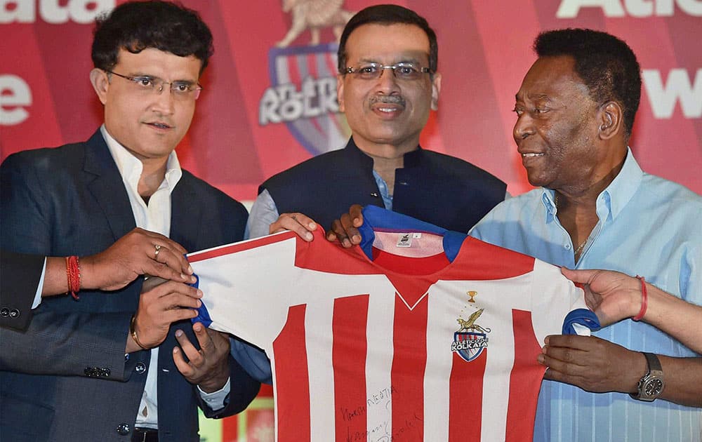 Legendary Soccer player Pele, former Indian cricketer Sourav Ganguly and Owner of Atletico de Kolkata Sanjiv Goenka holding the jersey of team during a program in Kolkata.