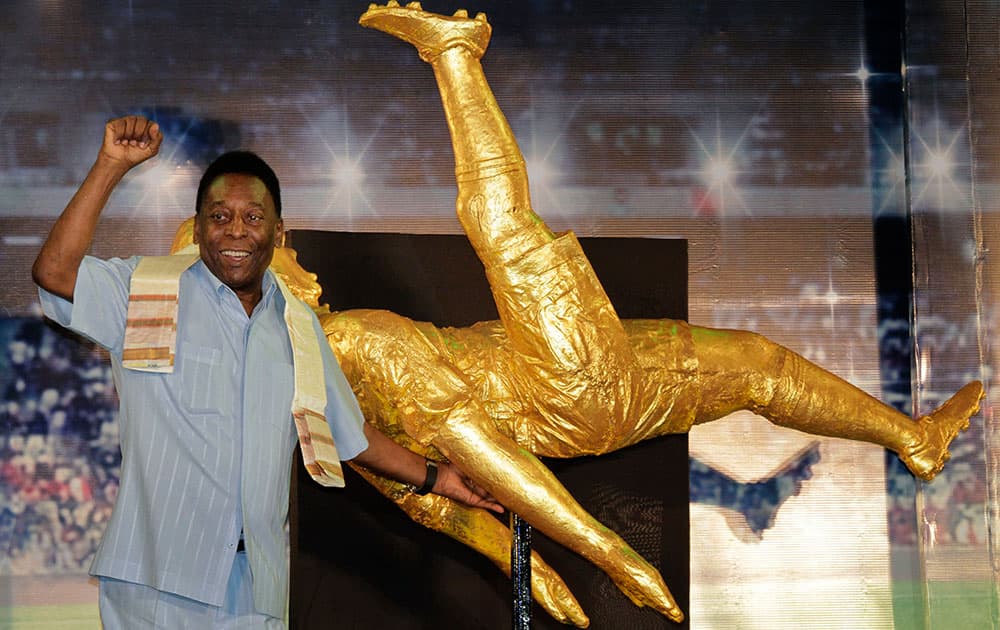 Brazilian football legend Pele near a life sized model presented to him during an interaction session with the students of NSHM Knowledge Campus in Kolkata.