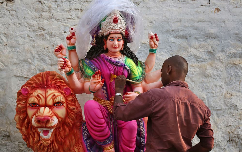 A artist gives finishing touches to an idol of Hindu Goddess Durga for Navratri festival celebrations, in Hyderabad.