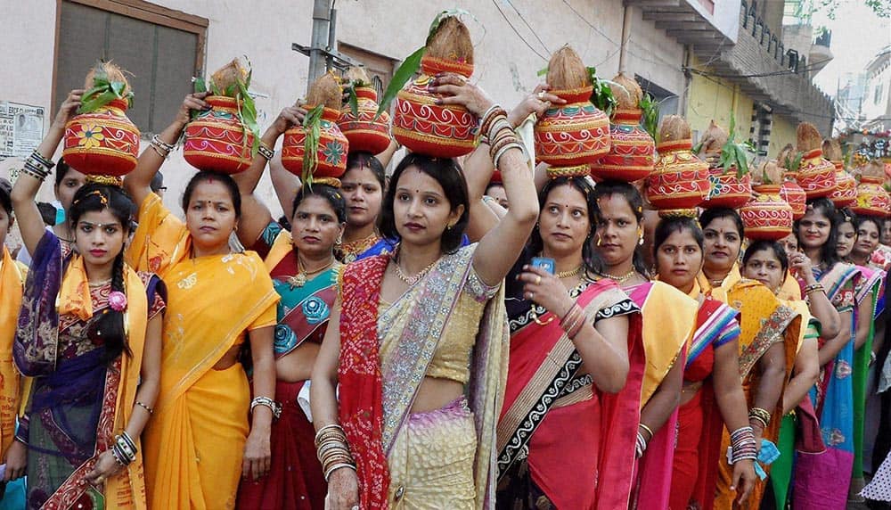 Devotees carrying Kalash during a Kalash Yatra taken out on the occasion of Maharaja Agarsen Jayanti in Mathura.