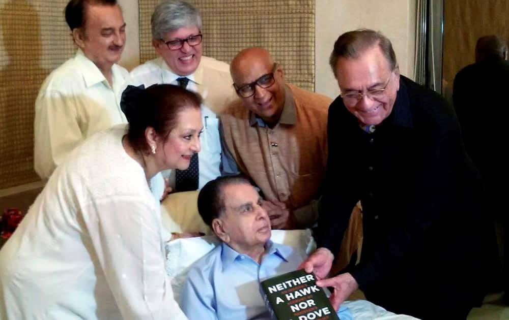 Former foreign minister of Pakistan Khurshid Mahmud Kasuri presents his book to bollywood veteran actor Dilip Kumar and his wife Saira Banu at the actors residence in Mumbai.