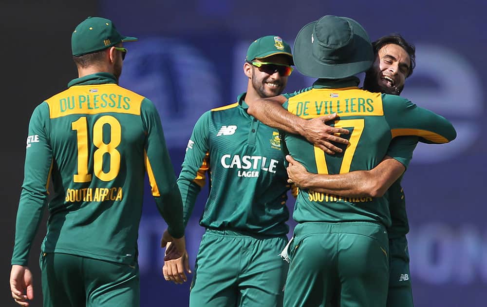 Imran Tahir and teammates celebrate a wicket during their second one day international cricket match in Indore.