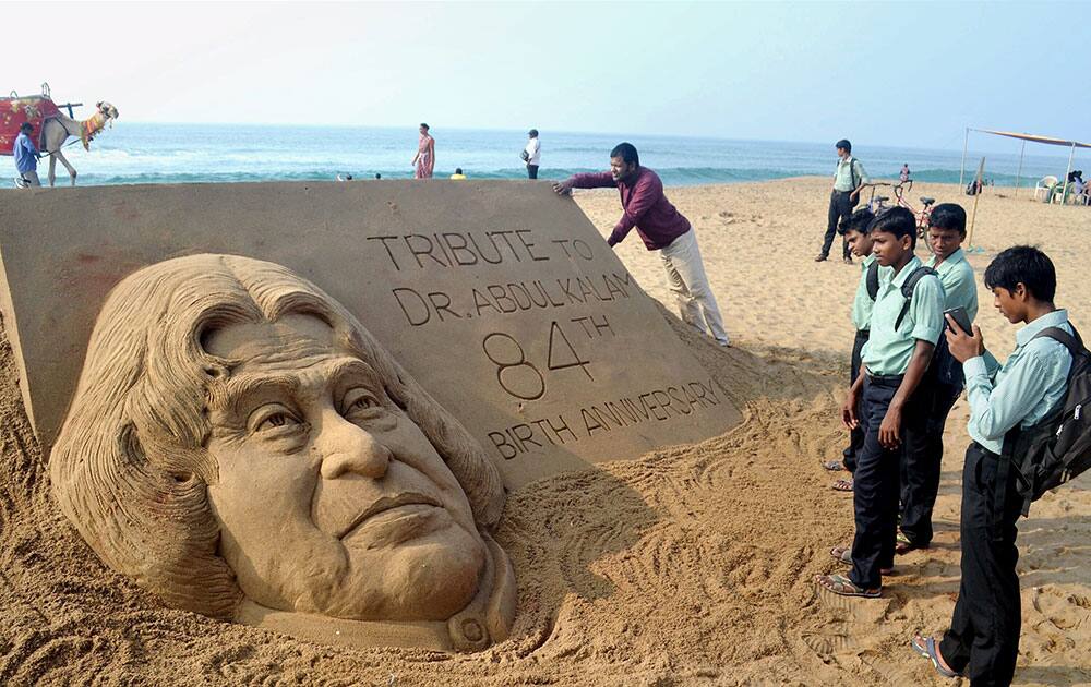 Renowned sand artist Sudarsan Pattnaik creates a sand sculpture of former President APJ Abdul Kalam to pay him tributes on his 84th birth anniversary at Golden Sea Beach, Puri, Odisha.