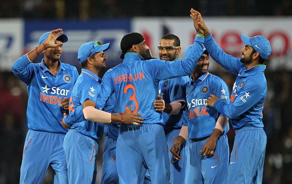 Indian players celebrate the wicket of South Africa's Quinton de Kock during their second one day international cricket match in Indore.