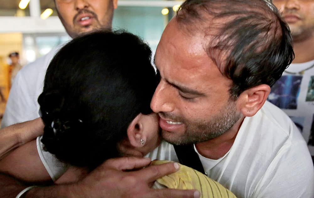 Sushil Kapoor, one of the nine Indian sailors freed after being held in Iran for two years on charges of smuggling oil, hugs his mother on his arrival at the Indira Gandhi International Airport.
