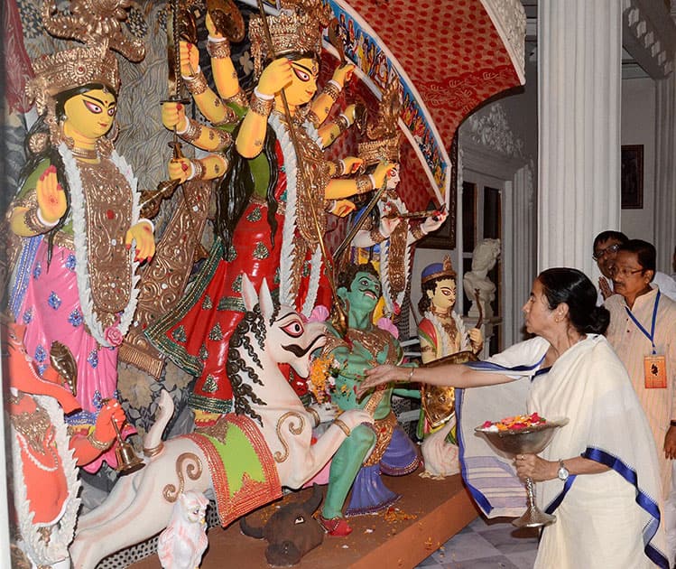 West Bengal Chief Minister Mamata Banerjee offers prayer during the inauguration of Goddess Durga puja pandal at Kumartully Sarvojanin.