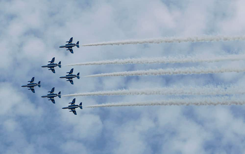 Japan Air Self-Defense Force's aerobatic team the Blue Impulse jets fly over during an event held ahead of Sunday's official triennial navy fleet review off Sagami Bay, south of Tokyo.