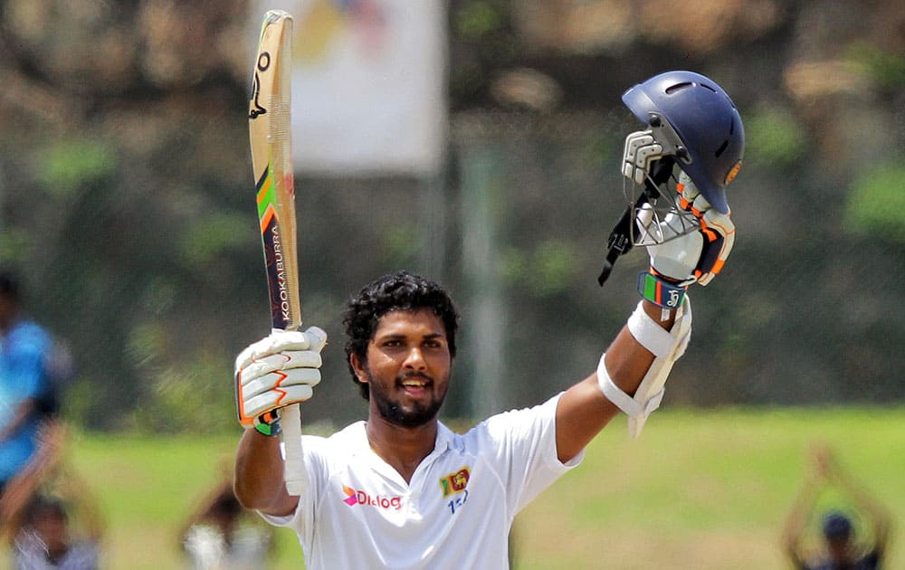 Sri Lanka's Dinesh Chandimal celebrates scoring a century during the second day of the first test cricket match against West Indies in Galle, Sri Lanka.