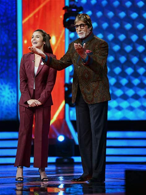 Bollywood actors Amitabh Bachchan with actress Alia Bhatt on the set of upcoming TV show in Mumbai.