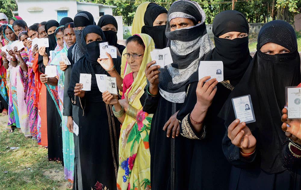 ers wait in queues to cast their vote during second phase of Bihar elections at Gaya.