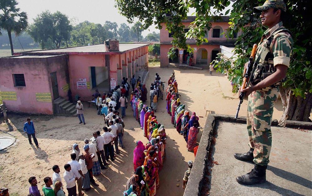 Voters wait in queue to cast their vote during second phase of Bihar elections at Gaya.