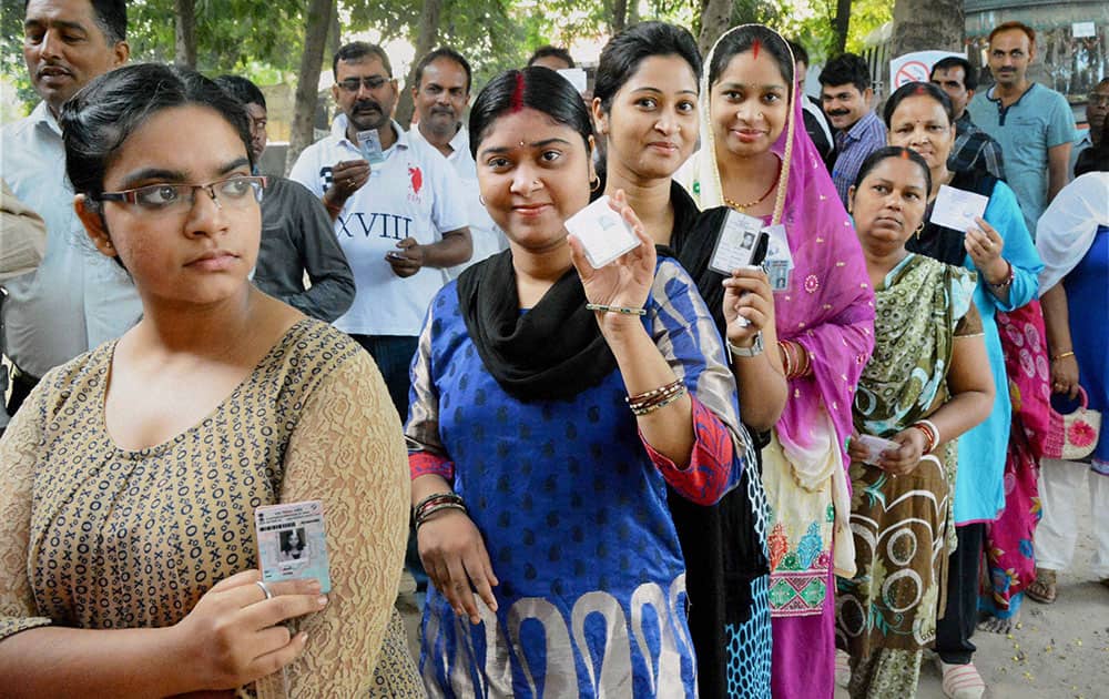Voters wait in queues to cast their vote during second phase of Bihar elections at Gaya.