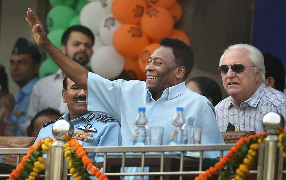 Brazilian football legend Pele waves as he watches the Under-17 boys final match of the Subroto Cup as Chief Guest at the Ambedkar Stadium in New Delhi.