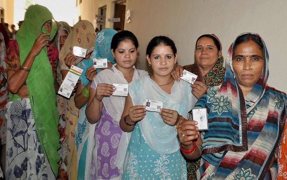Voters wait in a queue to cast their vote at polling booth during third phase of Uttar Pradesh Panchyat elections in Mathura.