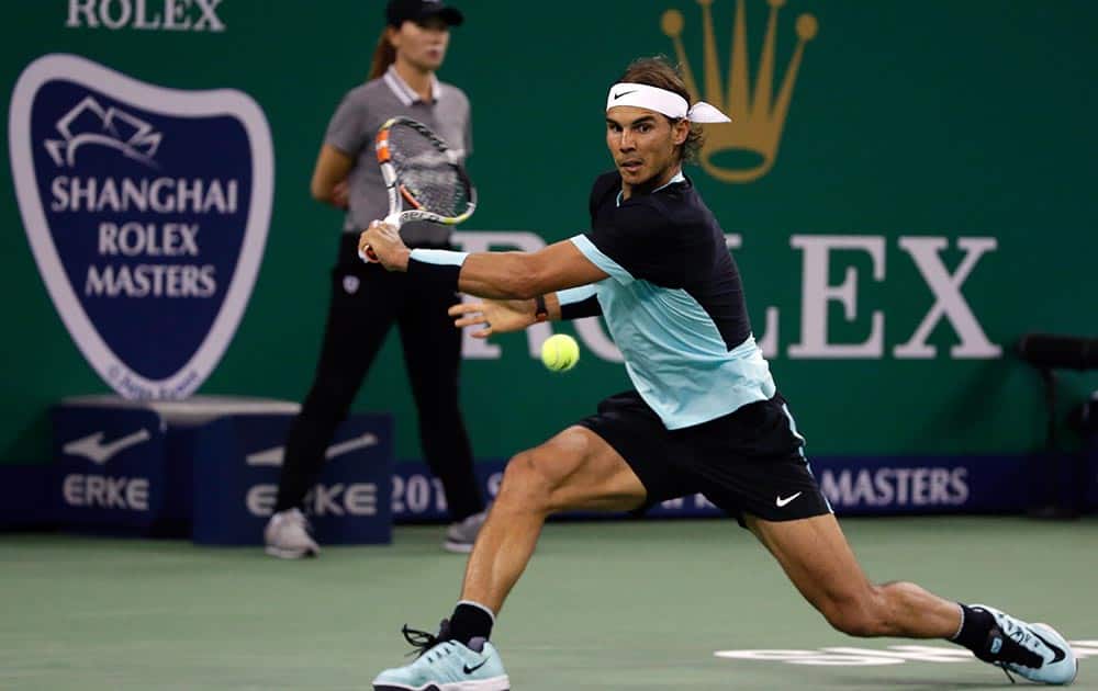 Rafael Nadal of Spain reaches for the ball as he plays against Jo-Wilfried Tsonga of France during their semifinal match of the Shanghai Masters tennis tournament in Shanghai, China.