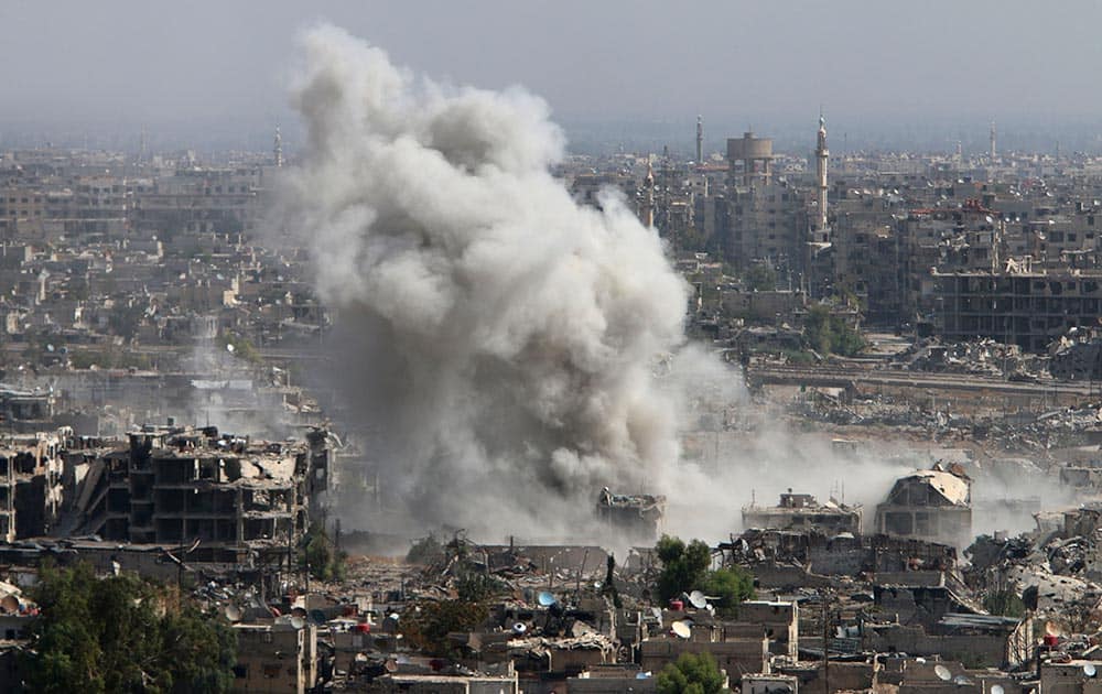 Smoke rises after shelling by Syrian army in Jobar, Damascus, Syria. Backed by Russian airstrikes, the Syrian army has launched an offensive in central and northwestern regions.