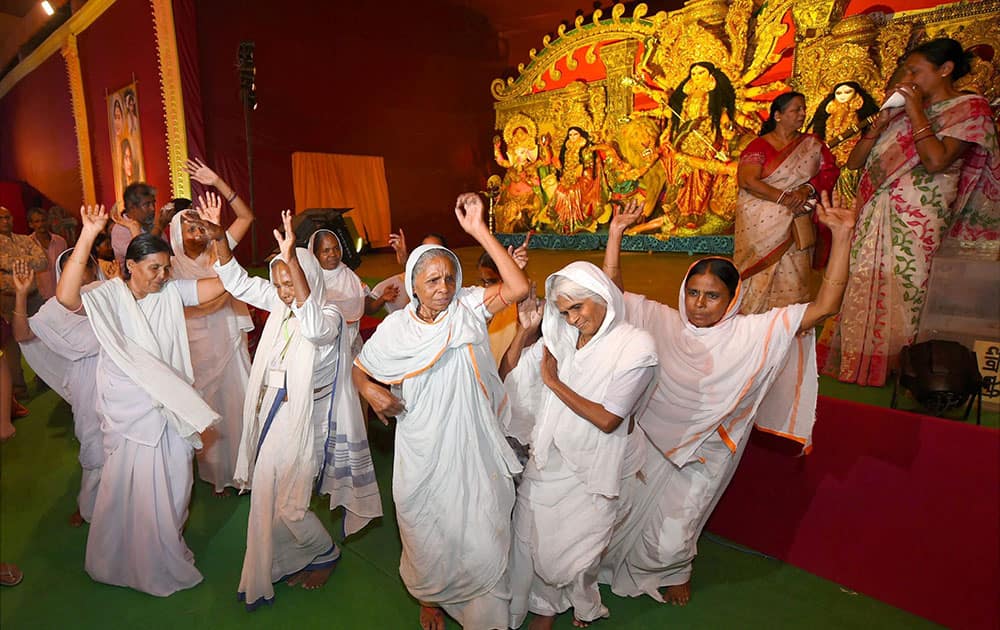 Widows of Vrindavan (mostly of West Bengal) dance during their visit at Aaram Bagh Durga pandal which is themed this year Women empowerment, organised by Aaram bagh Puja Samiti at Aaram Bagh Paharganj in New Delhi.