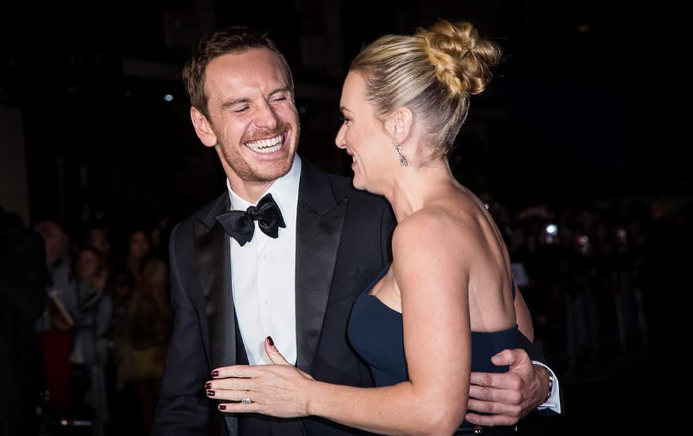 Michael Fassbender and Kate Winslet pose for photographers upon arrival at the premiere of the film Steve Jobs, as part of the London film festival in London.