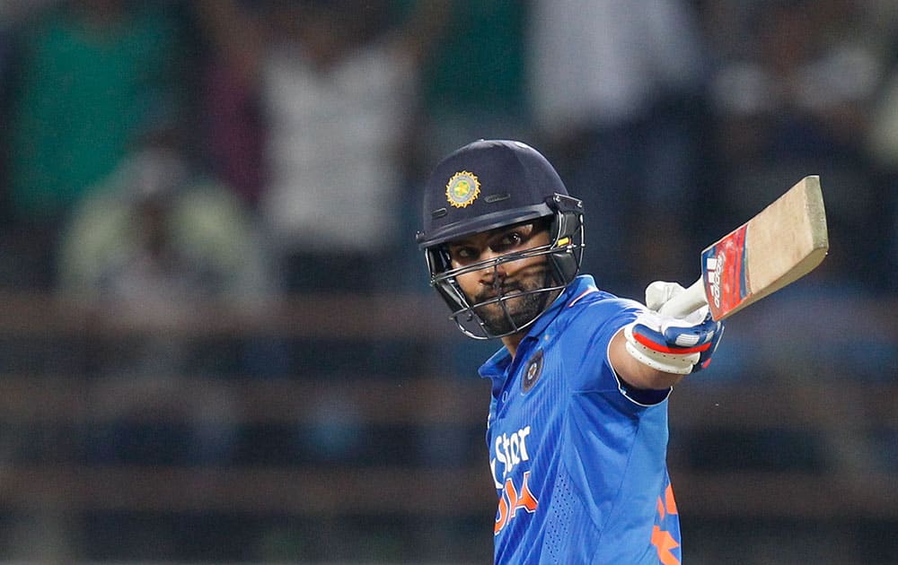 Rohit Sharma acknowledges his fifty runs during their third one-day international cricket match against South Africa in Rajkot.