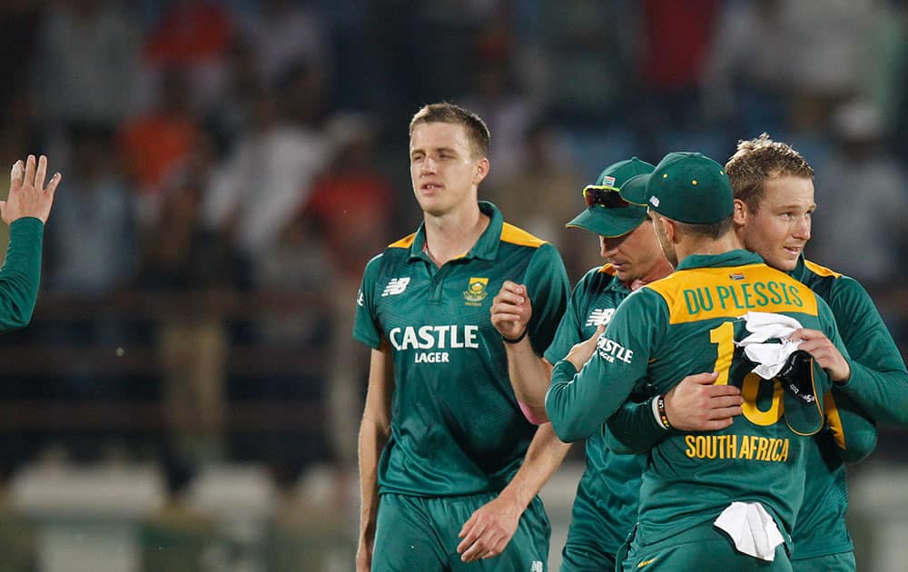 Morne Morkel walks back with teammates after they won their third one-day international cricket match against India in Rajkot. South Africa won by 18 runs.