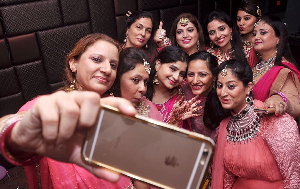 Women taking selfie during Durga puja festival on Tuesday in Patiala.