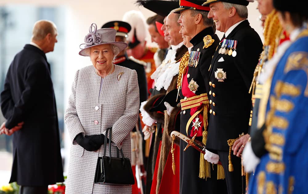 Britain's Queen Elizabeth smiles as she waits with dignitaries for the arrival of the II Chinese President Xi Jinping at the official welcome ceremony at Horseguards Parade in London.