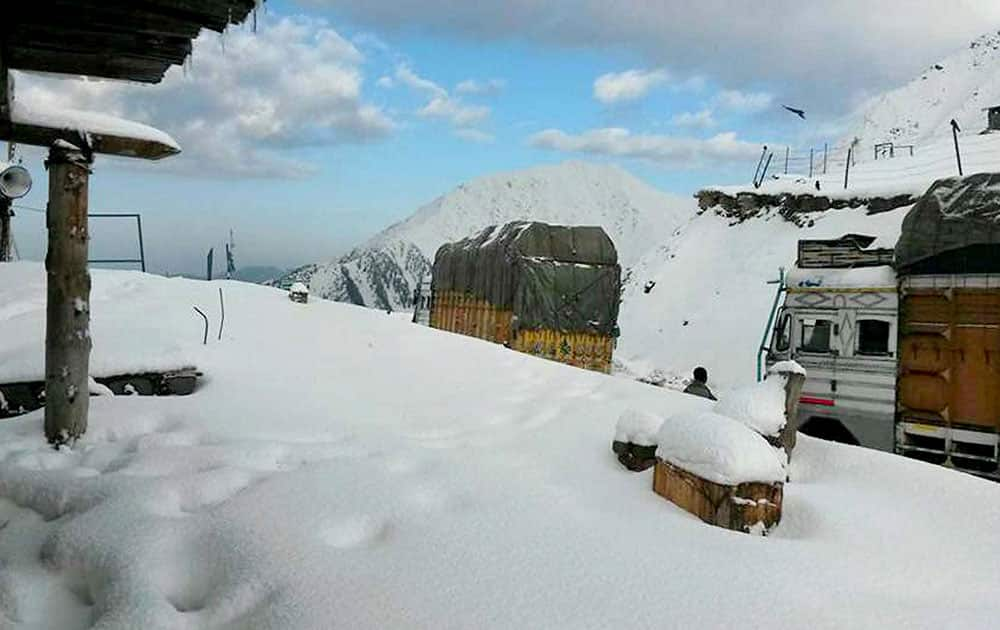 A view of snow covered Mughal Road after receiving seasons first snowfall in Peer Panchal range in Jammu and Kashmir.