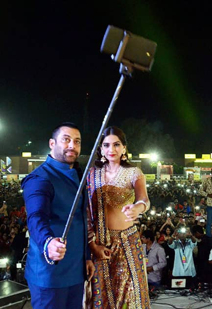 Actors Salman Khan take selfie with Sonam Kapoor during promotion of their upcoming film at a Navratri festival in Ahmedabad.