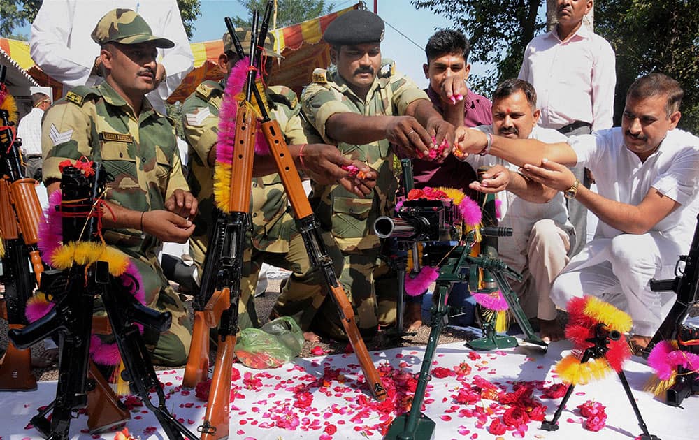 Border Security Force (BSF) soldiers perform Shastra Puja (worship of the weapons) on the occasion of Vijayadashmi at Khassa near Amritsar.