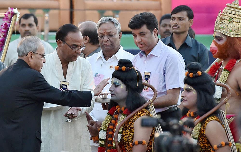 President Pranab Mukherjee performing aarti of artists enacting Lord Ram and Lakshman during Dussehra celebrations at Parade Ground in New Delhi.