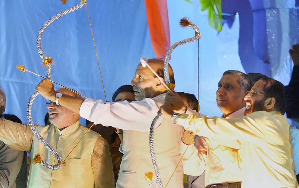 Home Minister Rajnath Singh holding a bow and arrow during Dussehra celebrations at Ramlila Ground.