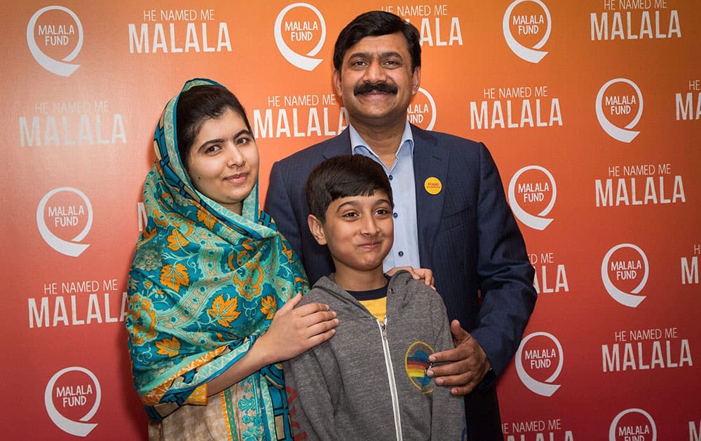 Malala Yousafzai, Atal Khan Yousafzai and Ziauddin Yousafzai pose for photographers upon arrival at the screening of the film He Named Me Malala in London.