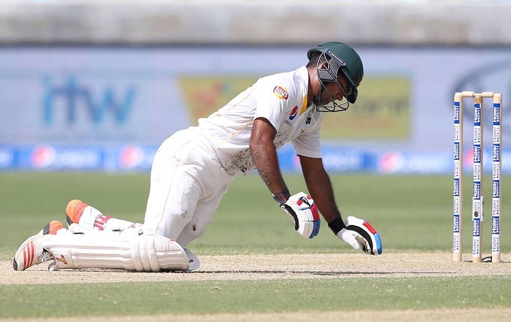 Pakistan's batsman Asad shafiq reacts after he was injured by England's pacer Mark Wood's ball during their Test cricket match at the Dubai International Stadium in Dubai, United Arab Emirates.