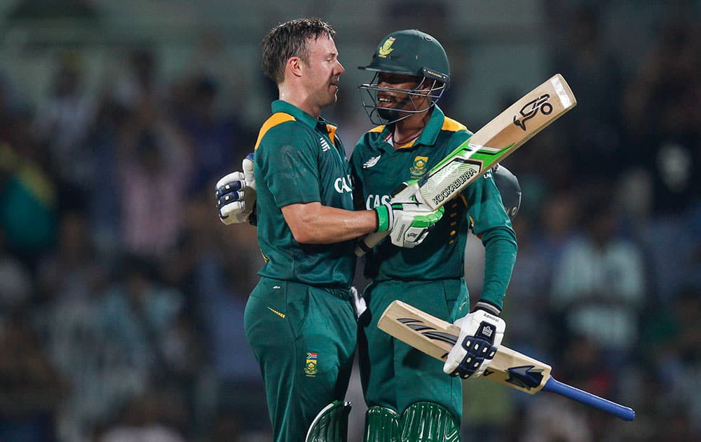 South Africa's captain A.B. de Villiers celebrates with Aaron Phangiso his hundred runs during their fourth one-day international cricket match against India in Chennai.
