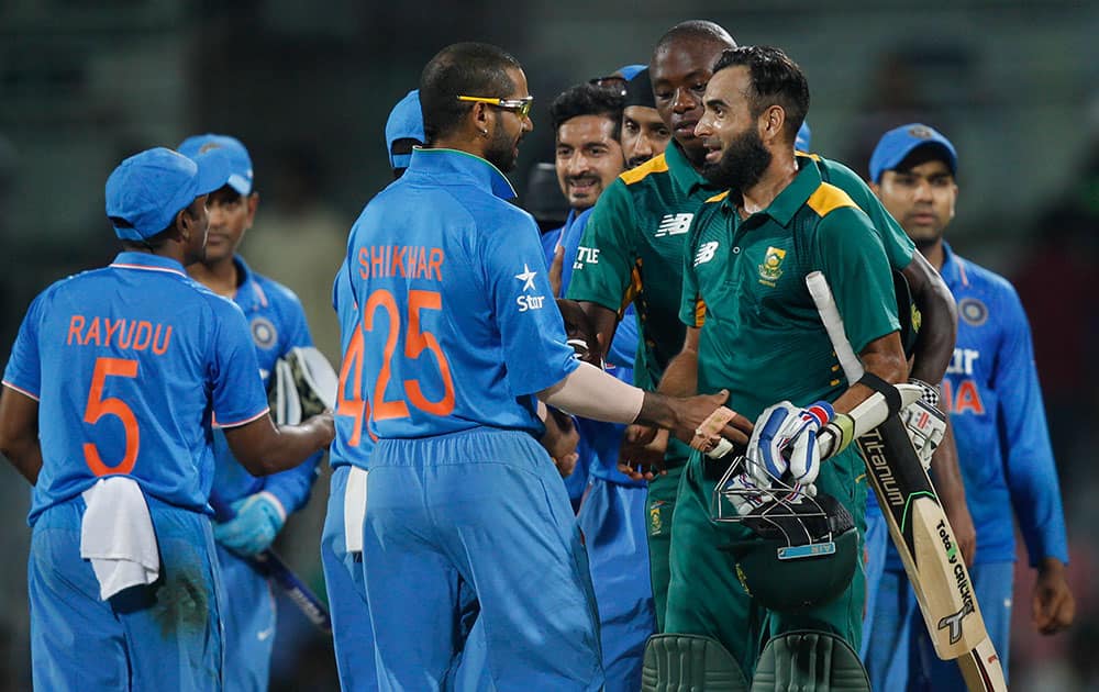 South Africa's Imran Tahir and Kagiso Rabada greet Indian team members after India won their fourth one-day international cricket match in Chennai.