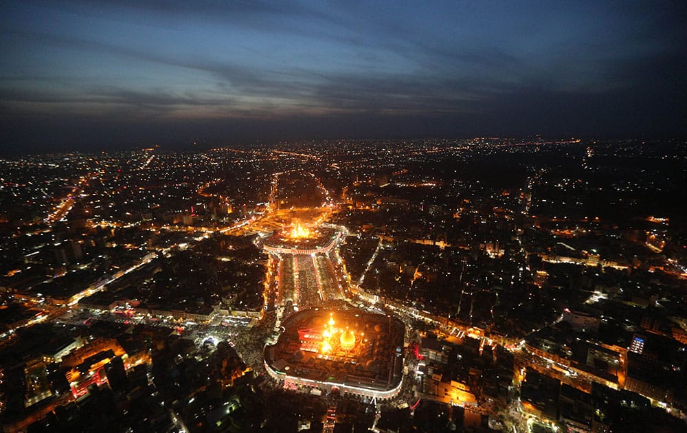 This aerial photo shows Shiite faithful pilgrims gather between, the holy shrine of Imam Hussein, top, and the holy shrine of Imam Abbas, bottom, during preparations for the Muslim holiday of Ashoura in the Shiite holy city of Karbala.