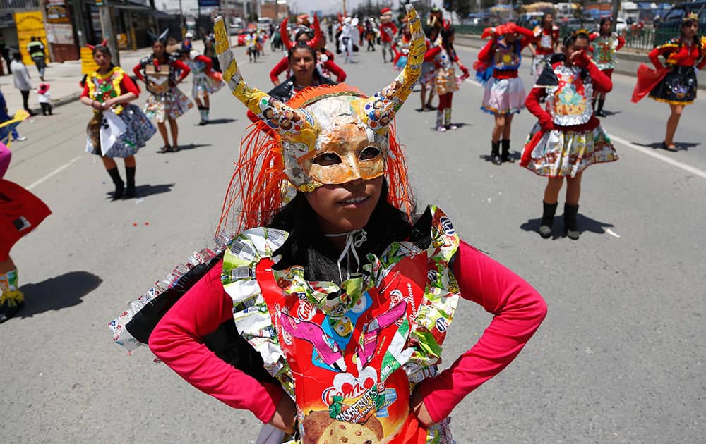 A youth dressed as a performer of the traditional 'La diablada' dance wears a costume made from recycled materials during a student parade in El Alto, Bolivia.