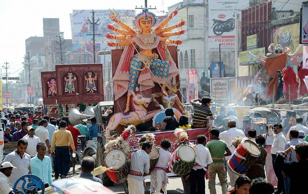 Devotees carrying an idol of Goddess Durga for immersion in a lake in Ranchi.