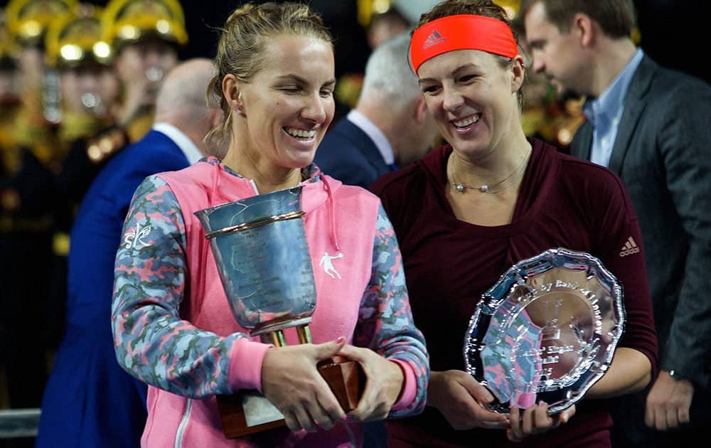 Russias Svetlana Kuznetsova, left, and Anastasia Pavlyuchenkova pose with their trophies in Moscow.