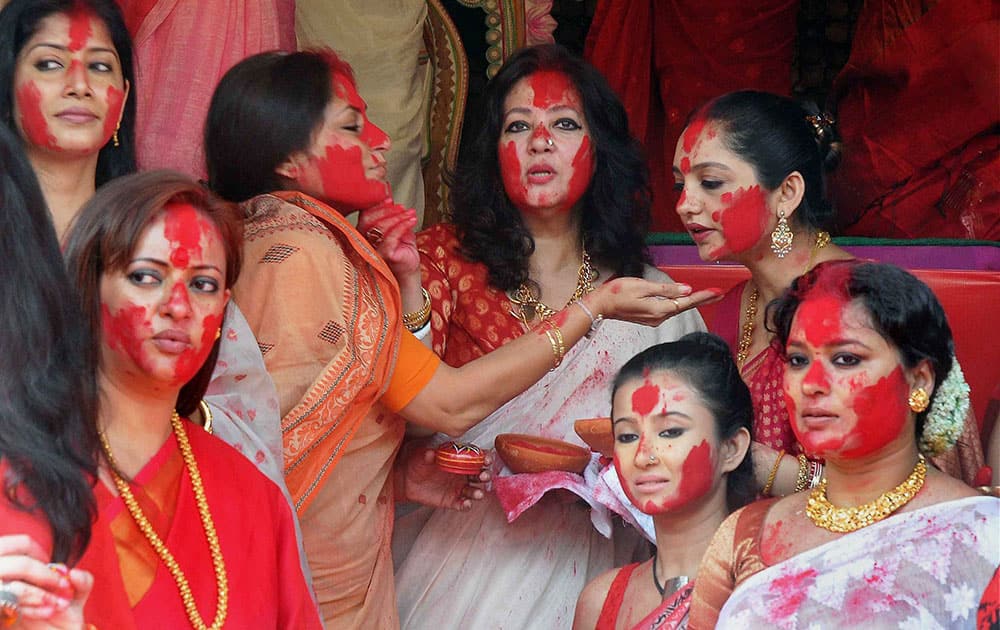 Bengali film actress & Trinamool Congress MP Moon Moon Sen(C) participate in Sindur Khela with film actress & BJP leader Rupa Ganguly and others during Vijaya Dashami celebrations, at Chalta Bagan Sarbojanin in Kolkata.