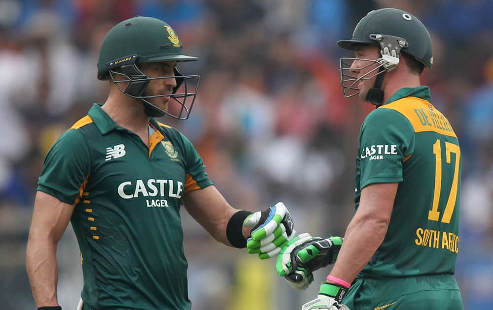 South Africa’s A.B. de Villiers, left, celebrates his fifty runs with Faf du Plessis during the final one-day international cricket match of a five-game series against India in Mumbai, India.