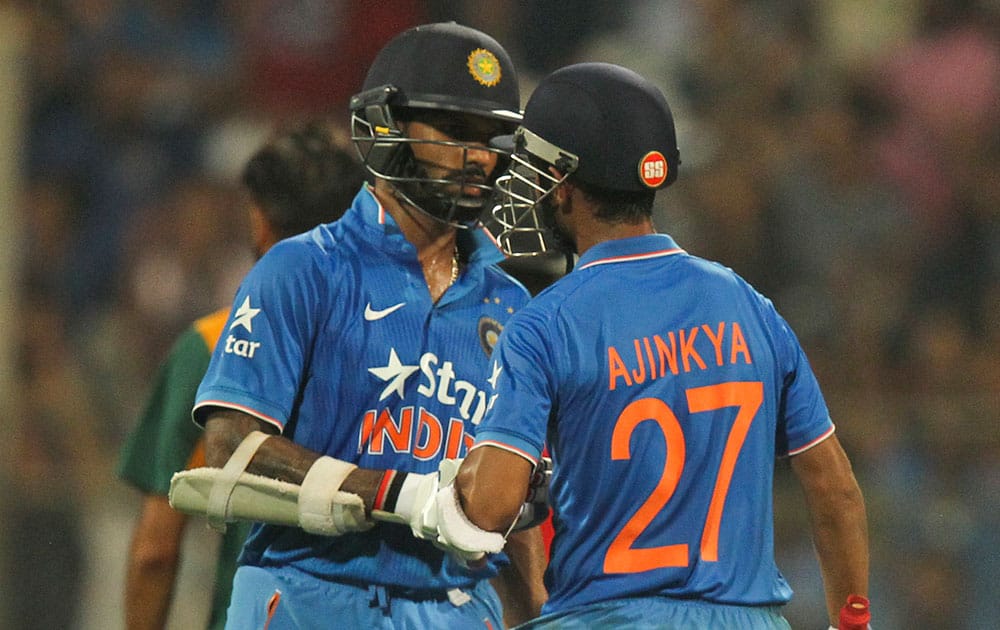 India's Ajinkya Rahane, right and Shikar Dhawan chat during the final one-day international cricket match of a five-game series against South Africa in Mumbai, India.