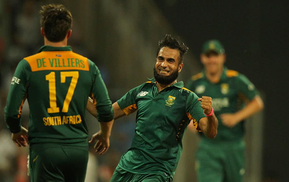 South African Imran Tahir, center celebrates the wicket of India’s Mahindra Singh Dhoni during the final one-day international cricket match of a five-game series in Mumbai, India.