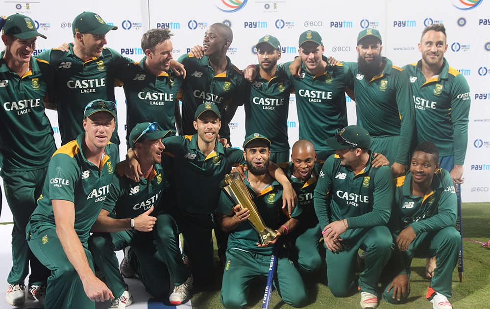 South African players pose with the series trophy after their victory against India in the final one-day international cricket match of a five-game series in Mumbai, India.