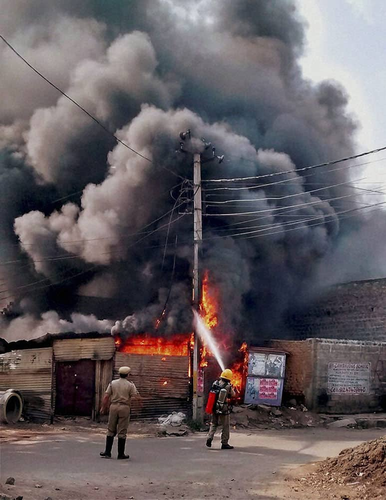 Fireman in action after fire broke out at a plastic godown in Hyderabad.