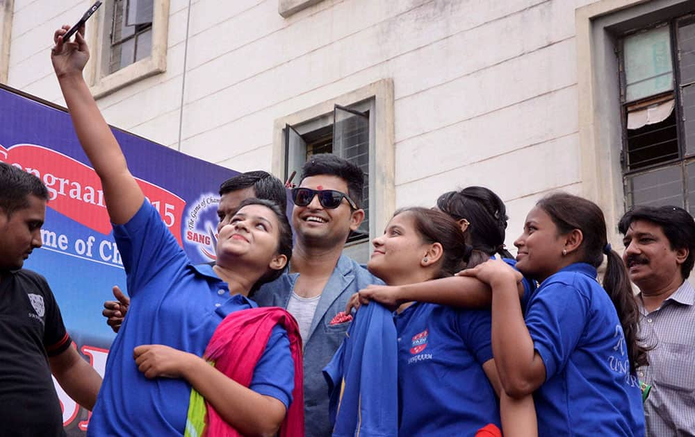 Students take selfie with Cricketer Suresh Raina during the inauguration of RKDF Sports Carnival in Bhopal.