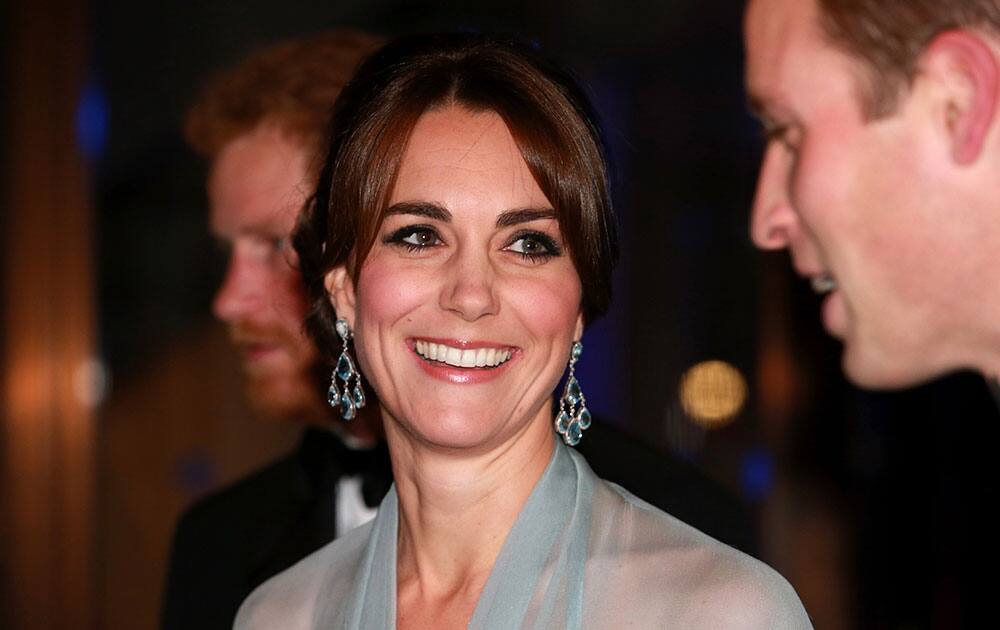 Britain's Prince William, right, Kate the Duchess of Cambridge and Prince Harry, in background, attend the World Premiere of the new James Bond film Spectre, in London.