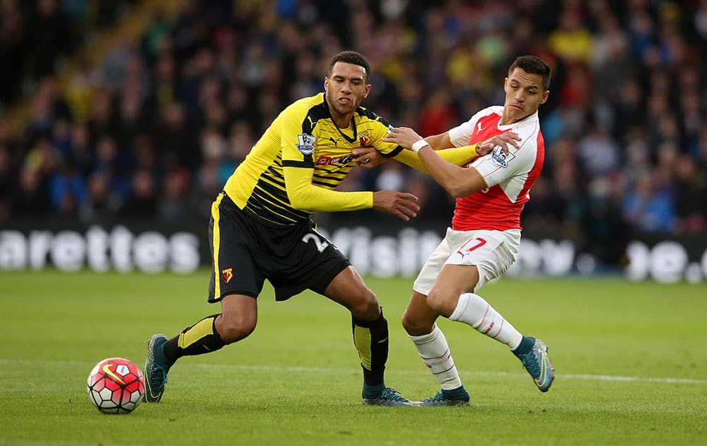 Watford's Etienne Capoue, left, and Arsenal’s Alexis Sanchez battle for the ball during their English Premier League soccer match at Vicarage Road, Watford, England.