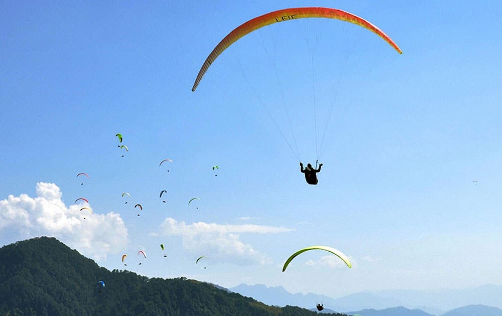 Paragliders take to the air on the 4th day of AAI Paragliding World Cup at Bir near Palampur, Dharamsala.