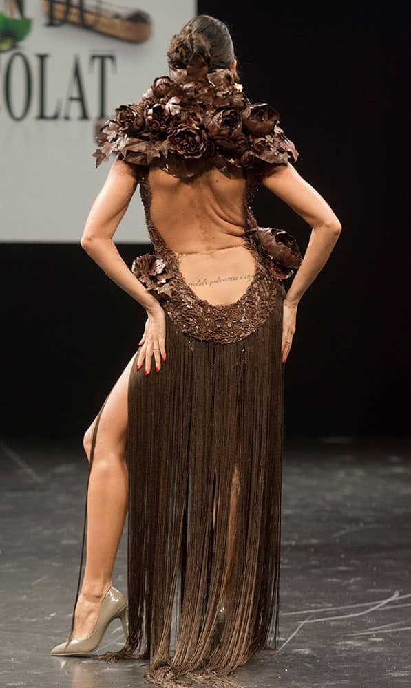 French TV Host Karine Lima presents a chocolate studded dress during a show as part of the chocolate fair in Paris.